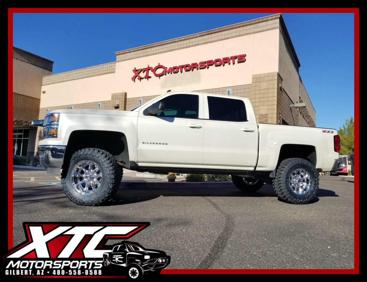 Eric brought us his 2014 Chevrolet Silverado 1500 for a ReadyLift Suspension Inc. 6.5" lift with rear FOX 2.0 Shox, 35x12.50R18 Toyo Tires M/T's wrapped around a set of KMC Wheels XD779 Chrome Badlands, & a set of AMP Research power steps.