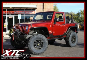 We recently finished up this 2010 Jeep Wrangler JK for Jill. We installed a ReadyLift Suspension Inc. 4" lift with adjustable trac bar, SuperFlex control arms and FOX 2.0 Performance Series Reservoir Adjustable shocks, 35x12.50R17 Nitto Trail Grappler tires on her American Outlaw Black Bunker Wheels, Poison Spyder Customs Brawler Mid front bumper w/skid plate and fairlead mount with a WARN VR-8S 8,000lb winch with synthetic rope, Poison Spyder Customs RockBrawler II rear bumper with tire carrier and backup light kit, Ricochet rockers and Body Armor, aluminum Crusher Fenders front and rear, inner fender kits front and rear, Warrior Products smooth corner guards, Borla cat-back exhaust system, aFe POWER air intake, and a Cobra C 75 WX ST CB Radio.